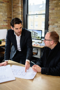 Architect consulting client on building conversion