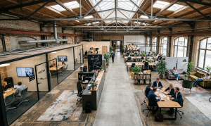 Flexible office layout with breakout areas and meeting spaces inside a converted warehouse workspace