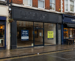 Vacant retail shop on UK high street showing underperforming retail property
