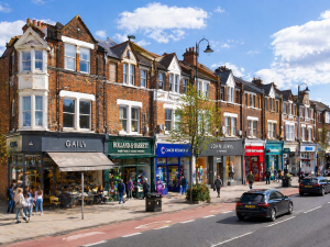High street mixed-use buildings in the UK with retail shops below and residential units above