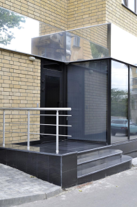 Separate entrance and staircase access to upper floor flats above shop in the UK
