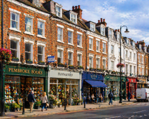 UK high street with shops at ground level and upper floors above showing mixed-use potential